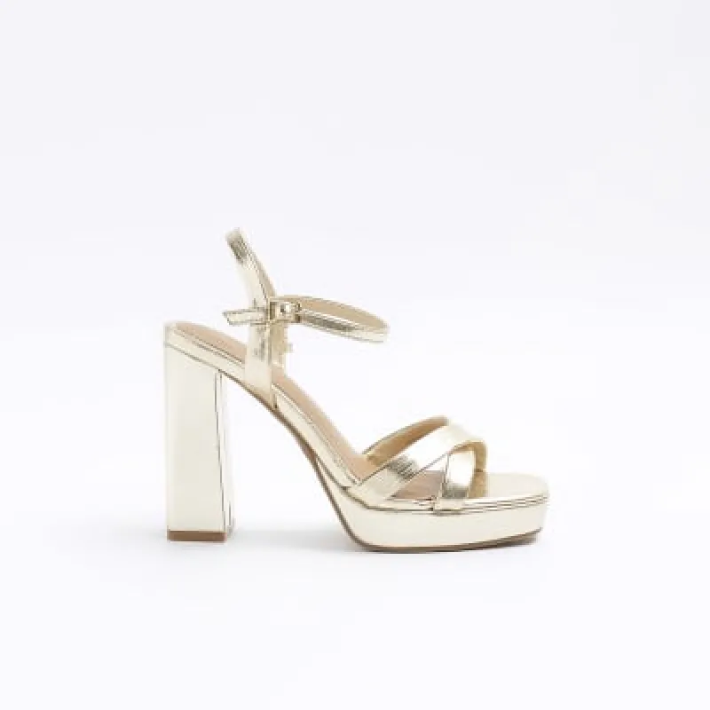 Gold crossed strap heeled sandals sold by River Island