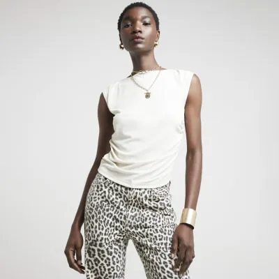 Cream ribbed ruched side vest top sold by River Island