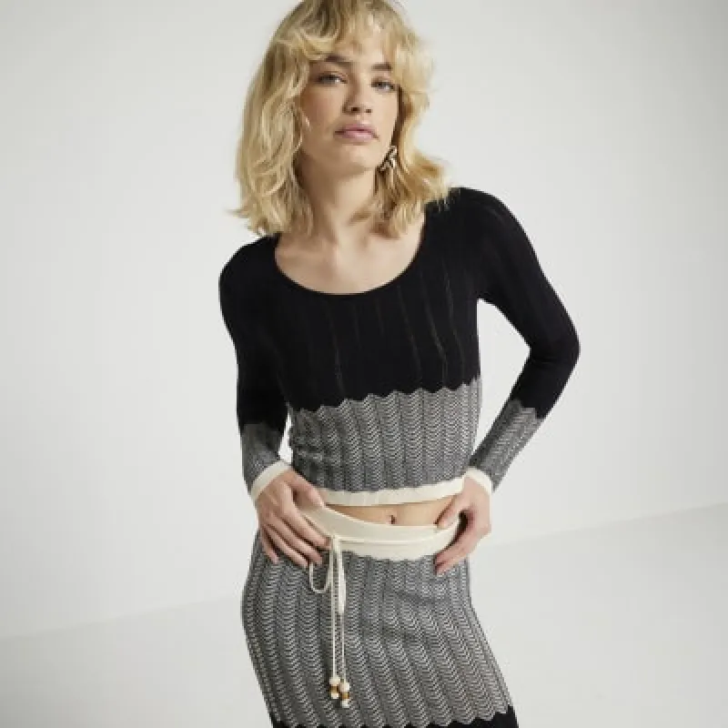 Black chevron knit long sleeve top sold by River Island