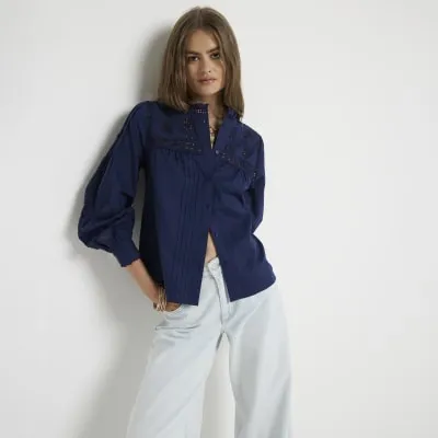 Navy pleated smock broderie blouse sold by River Island