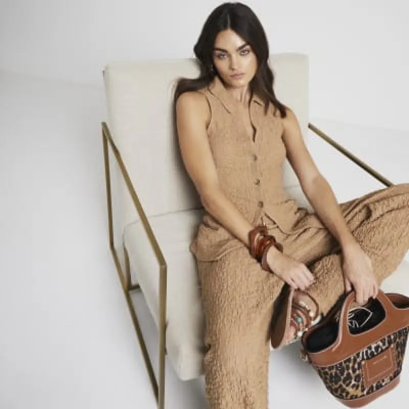 Beige textured sleeveless shirt sold by River Island