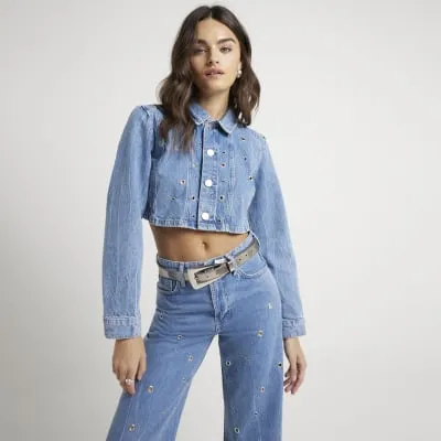 Blue eyelet detail cropped denim jacket sold by River Island
