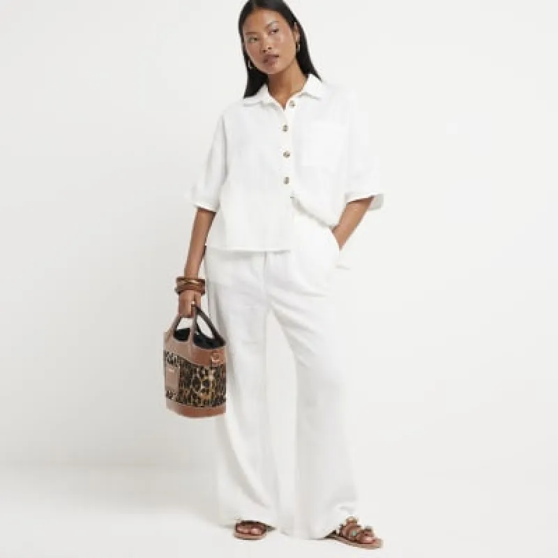 Petite White Textured Wide Leg Trousers sold by River Island