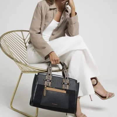 Black panelled webbing tote bag sold by River Island