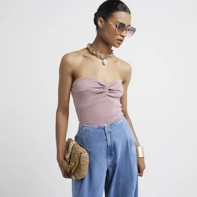 Pink washed knot front bandeau top sold by River Island