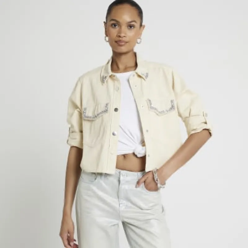 Cream denim embellished crop shacket sold by River Island