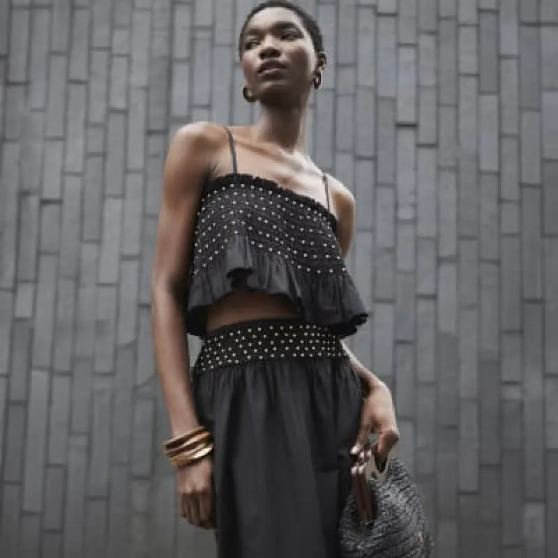 Black beaded poplin crop top sold by River Island