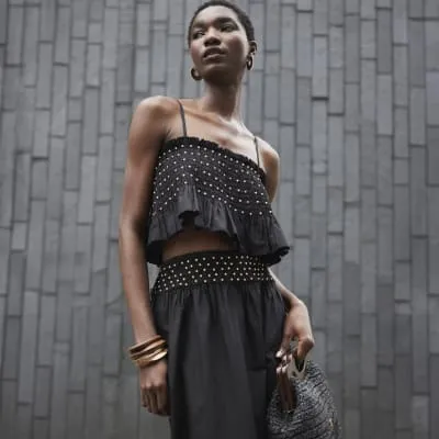 Black beaded poplin crop top sold by River Island