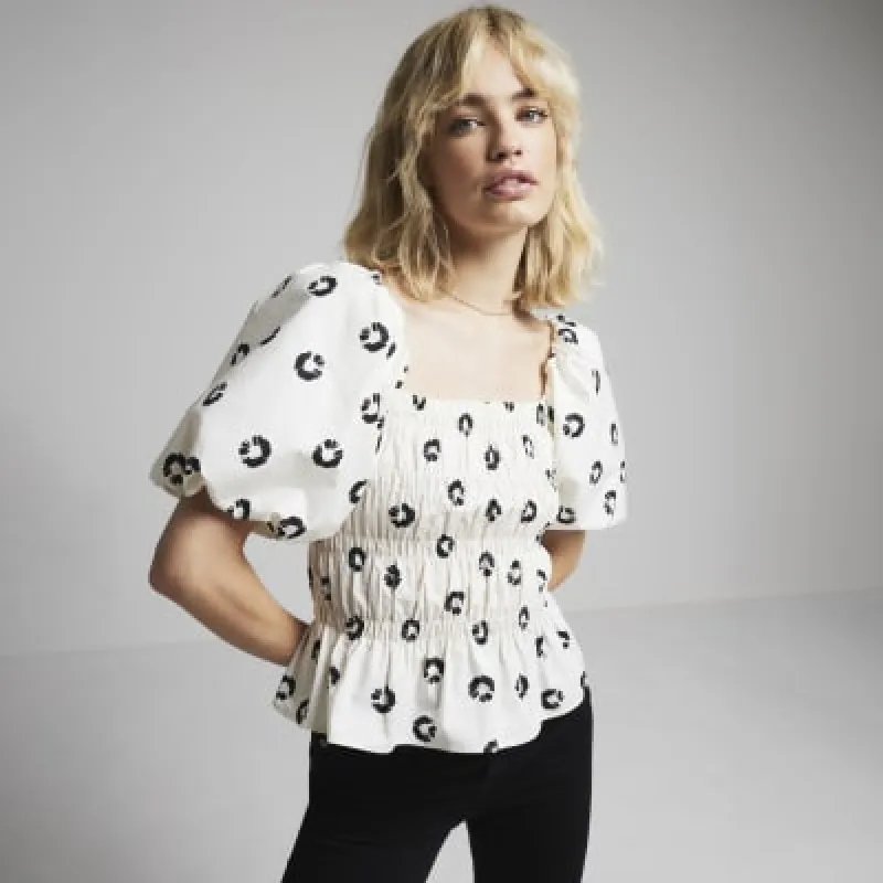 Cream floral shirred top sold by River Island