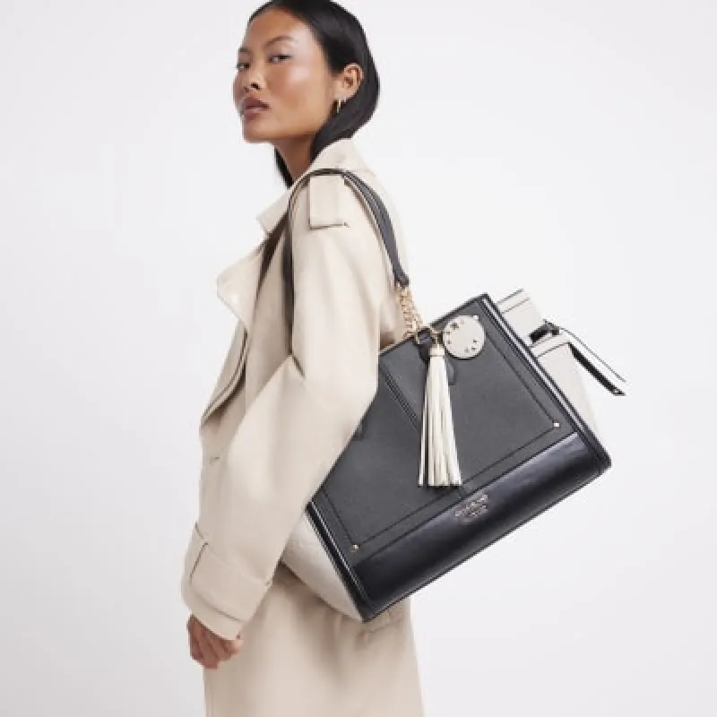 Black embossed panel tote bag sold by River Island