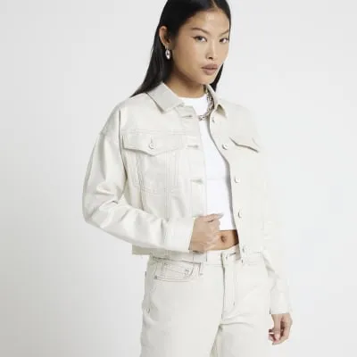 Petite beige glitter coated denim jacket sold by River Island