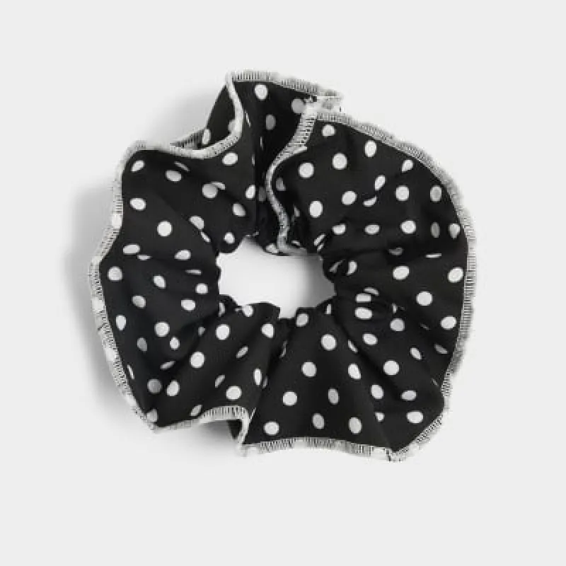 Black spot hair scrunchie sold by River Island