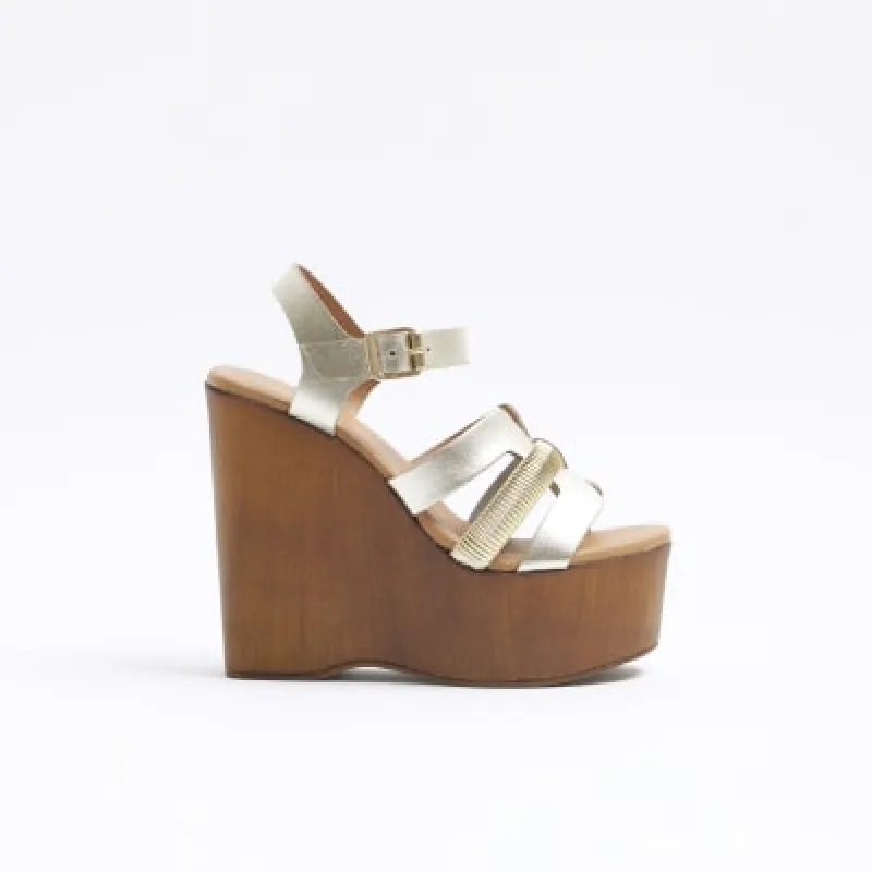 Gold leather strappy wedge sandals sold by River Island