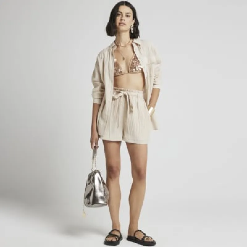 Beige textured tie waist shorts sold by River Island