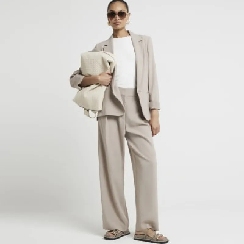 Beige elasticated wide leg trousers sold by River Island