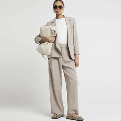 Beige elasticated wide leg trousers sold by River Island