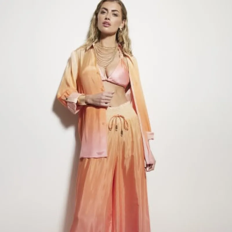 Pink ombre beach trousers sold by River Island