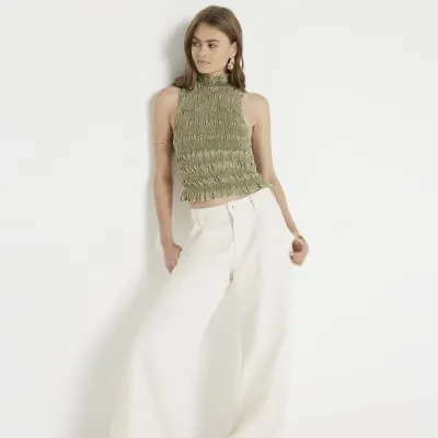 Green shirred high neck top sold by River Island