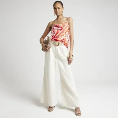 Red satin cowl neck scarf print cami sold by River Island