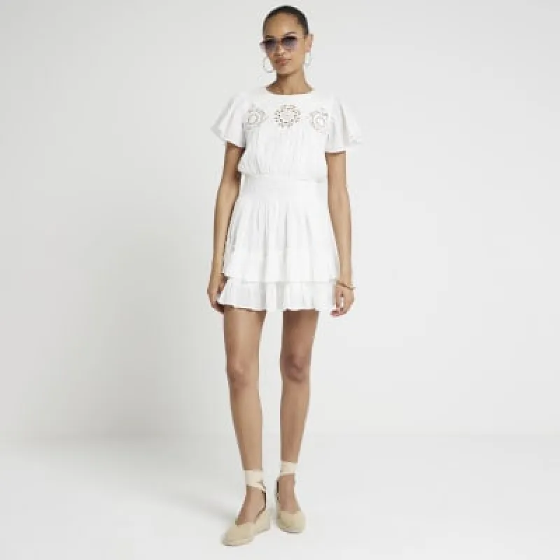 White cut out skater mini dress sold by River Island