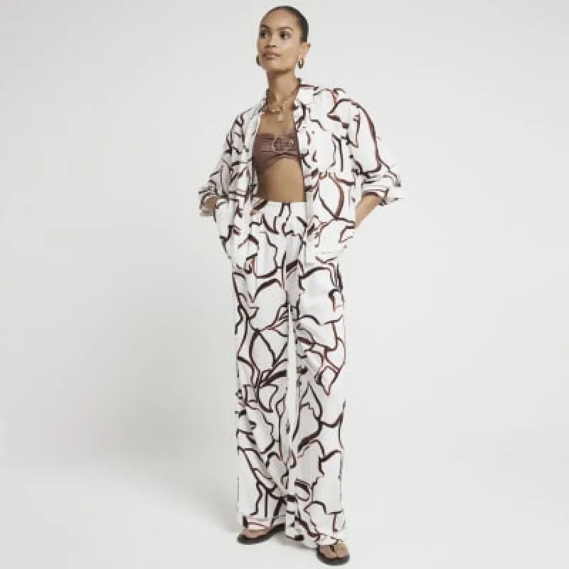 Brown abstract wide leg elasticated trousers sold by River Island