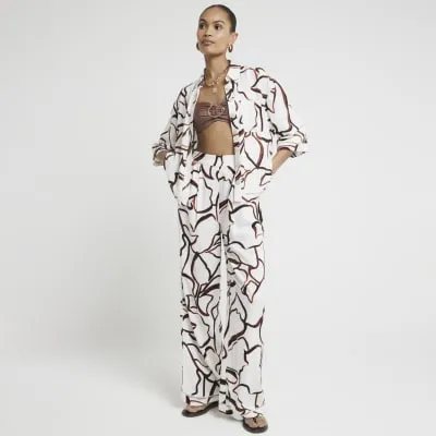 Brown abstract wide leg elasticated trousers sold by River Island