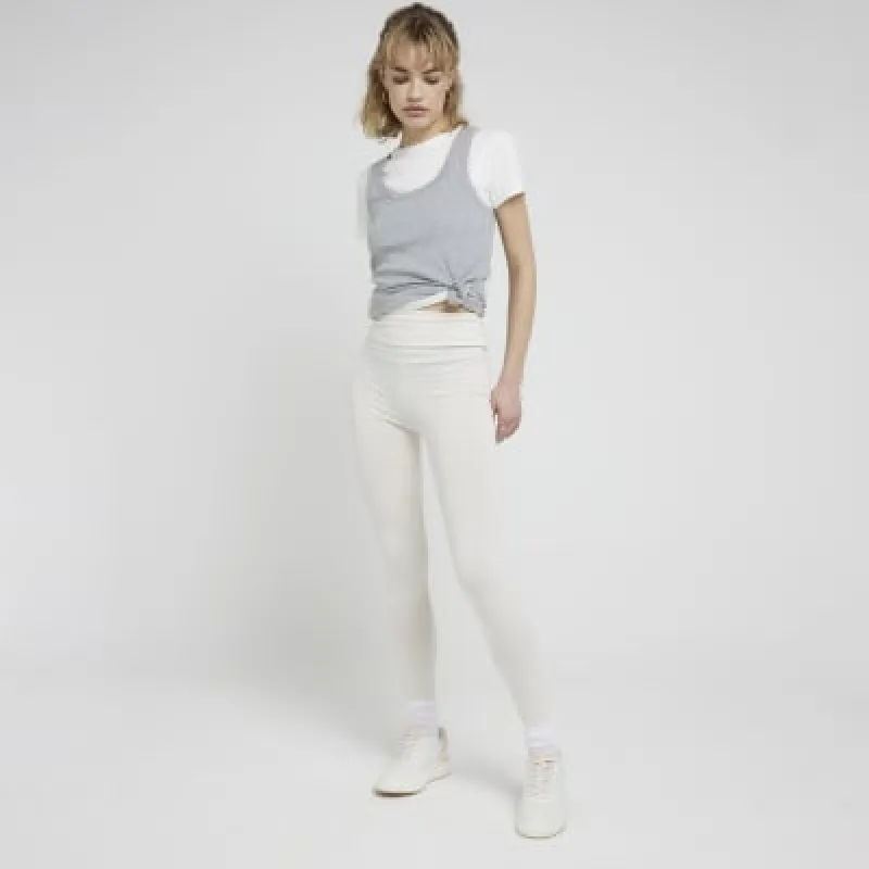 Cream high waisted leggings sold by River Island