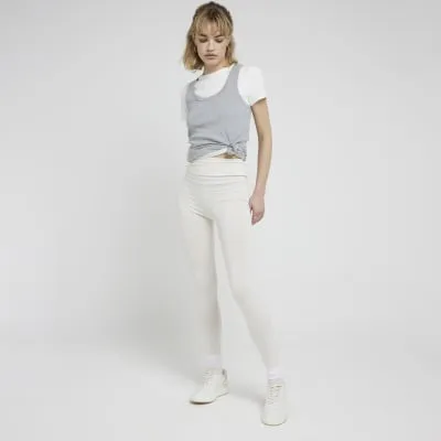 Cream high waisted leggings sold by River Island