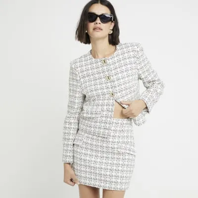 White boucle mini skirt sold by River Island