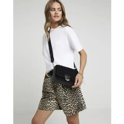 Black quilted cross body bag sold by River Island