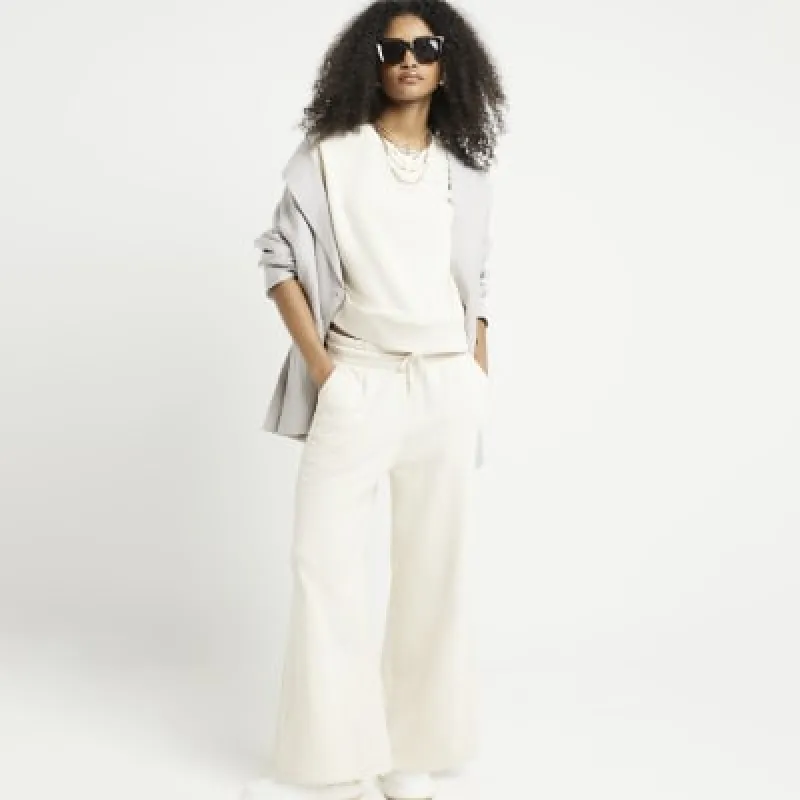 Beige wide leg crop joggers sold by River Island