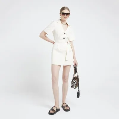 Beige belted skort playsuit sold by River Island