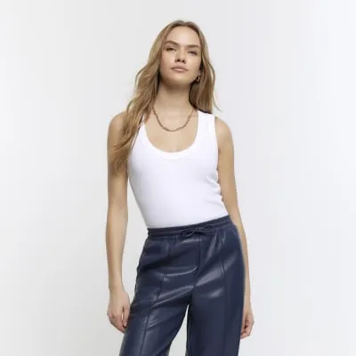 White scoop neck vest top sold by River Island