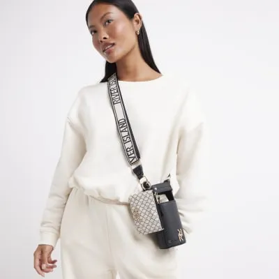 Black RI monogram cross body bottle holder sold by River Island
