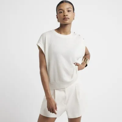 Gold knitted tank top sold by River Island