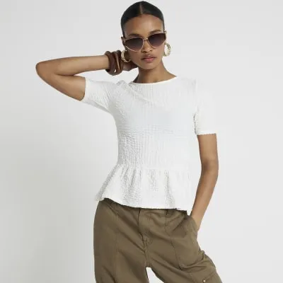 Cream textured peplum t-shirt sold by River Island