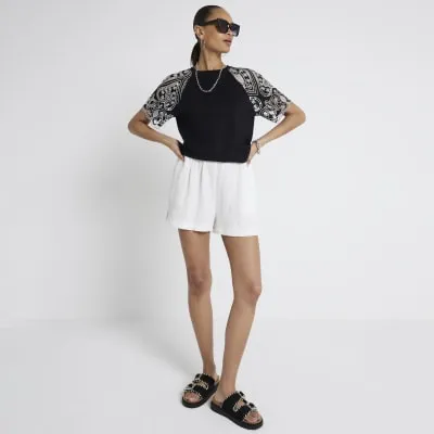 Black broderie detail t-shirt sold by River Island