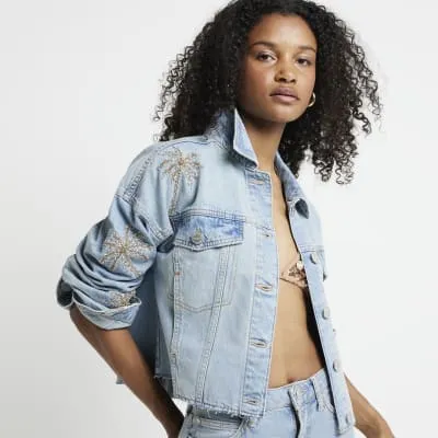 Blue sequin embellished denim jacket sold by River Island