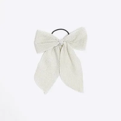 Green stripe bow hair band sold by River Island