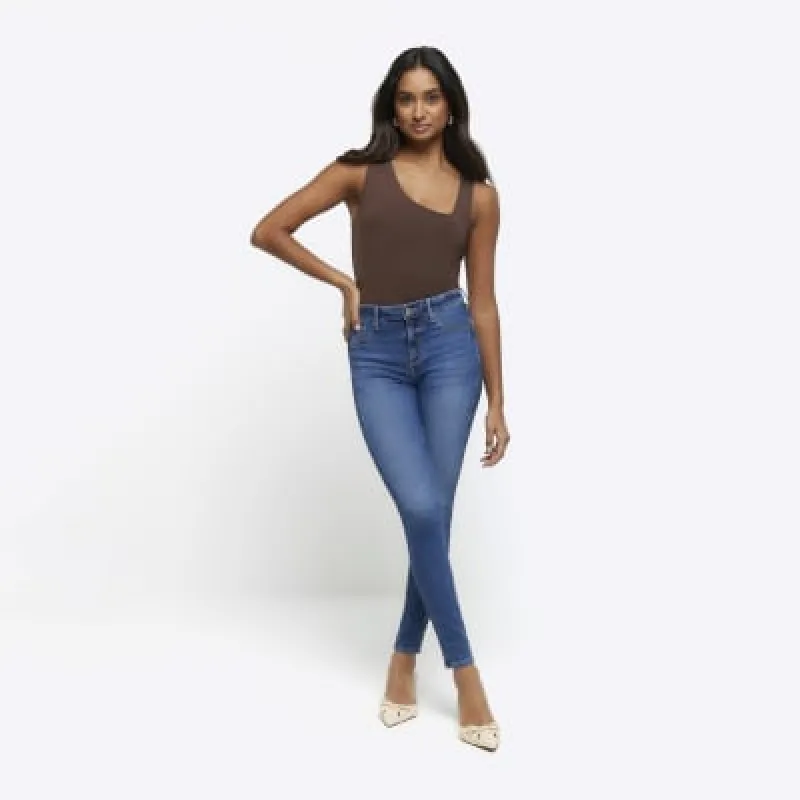 Blue mid rise bum sculpt skinny jeans sold by River Island