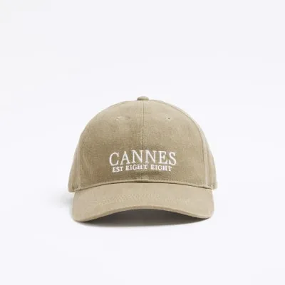 Green Cannes embroidered cap sold by River Island