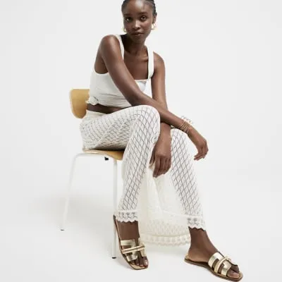 Gold leather flat sandals sold by River Island