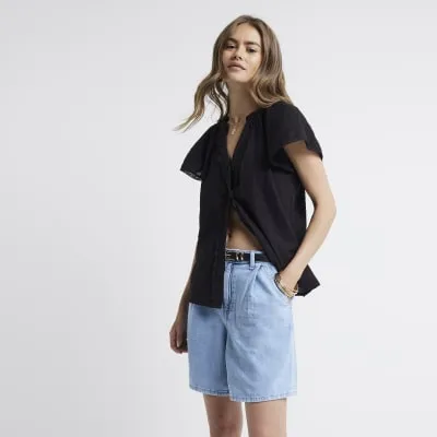 Black frill V-neck blouse sold by River Island