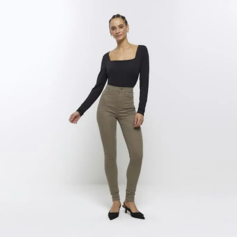 Khaki high waisted skinny jeans sold by River Island