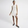 Beige pleated skirt sold by River Island