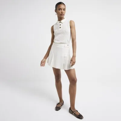 Beige pleated skirt sold by River Island