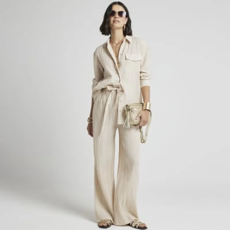 Beige textured wide leg trousers sold by River Island