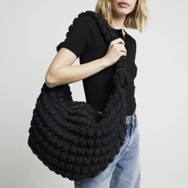 Black quilted scoop shoulder bag sold by River Island