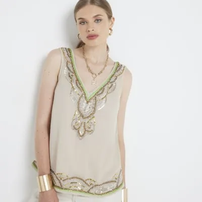 Beige embellished tank top sold by River Island