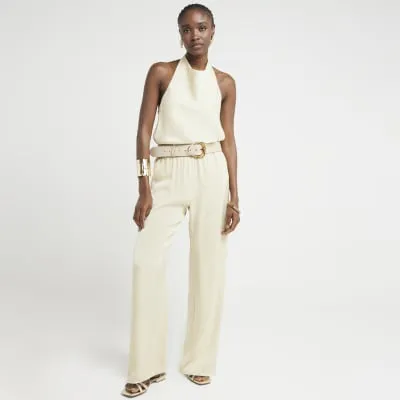 Beige satin halter neck top sold by River Island